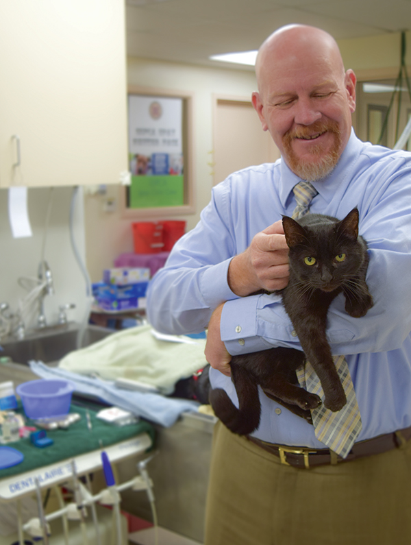 Sacramento SPCA CEO, Kenn Altine, enjoys a comforting moment with Tomasina prior to her surgery in the shelter’s spay & neuter clinic.