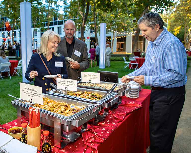Reeve-Knight-Team-enjoying-Fats Reeve-Knight Construction’s Kerry Bal and Todd Swanson, and Heather Swanson of Ameriprise Financial, enjoy the feast prepared by Fat Family Restaurants